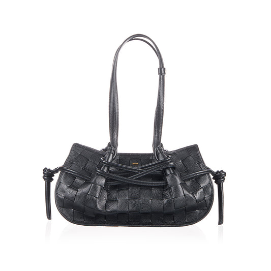 Black woven handbag with decorative straps.